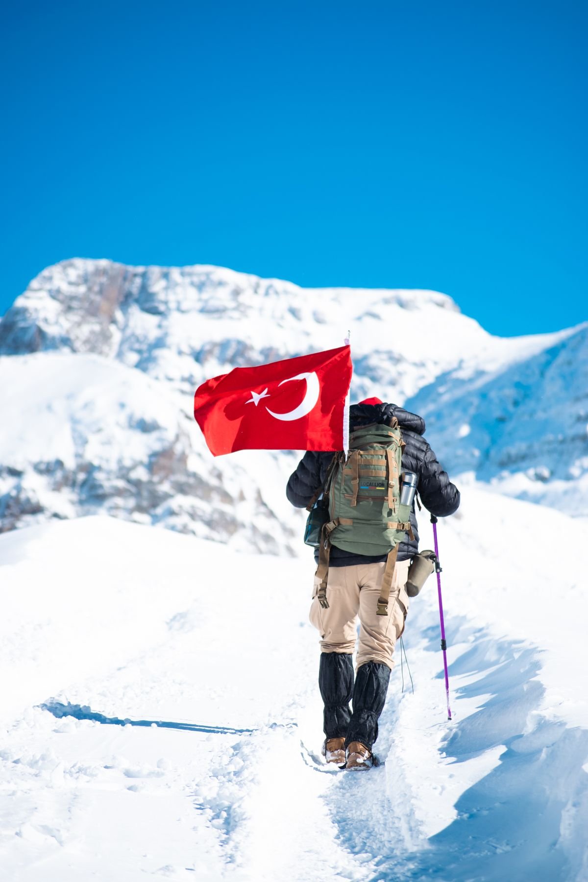 Mountain path with flag at summit